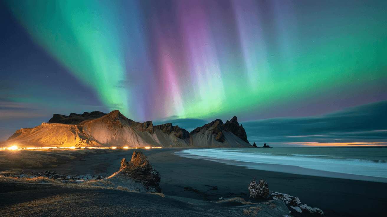 An Icelandic volcanic landscape featuring a striking black sand beach, illuminated by the vibrant colors of the aurora b